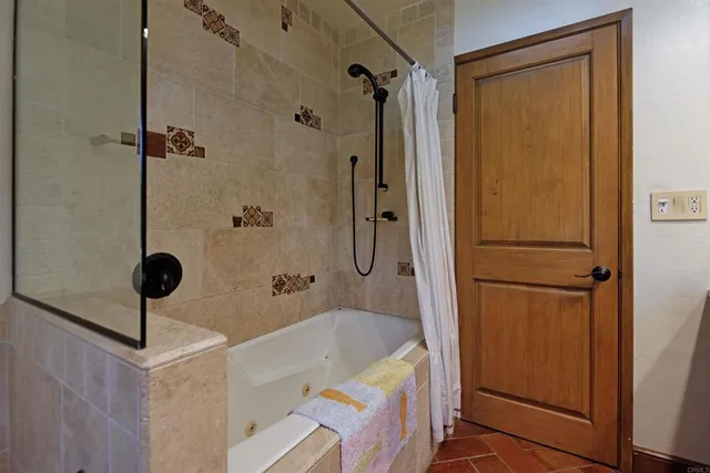 a bathroom with a tub and a shower