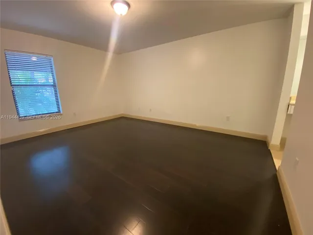 a view of room with window and wooden floor