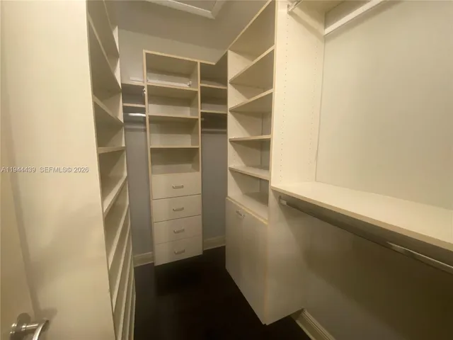 a view of walk in closet with empty racks