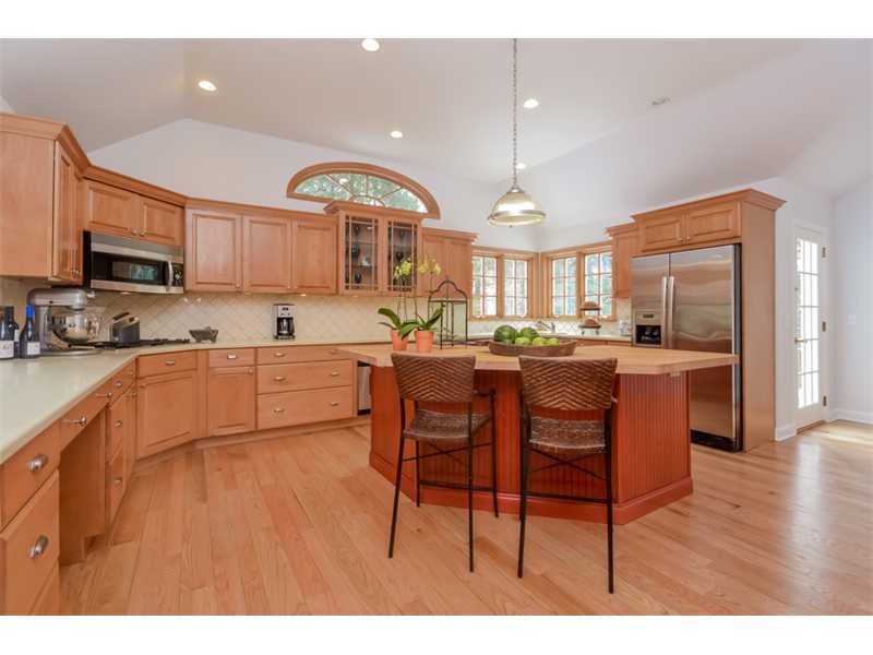 154 Middlesex Road Darien, CT 06820 - Photo 6 of 20 a kitchen with a table chairs refrigerator and microwave