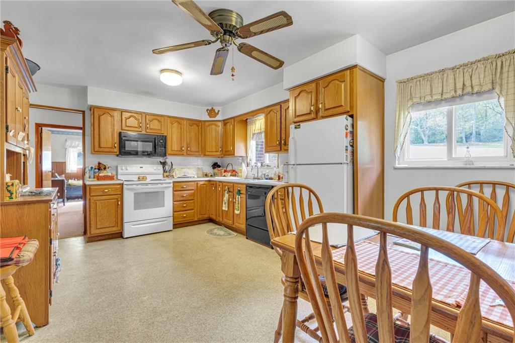 136 Kelley Road Industry, PA 15052 - Photo 2 of 35 a kitchen with table chairs cabinets and appliances