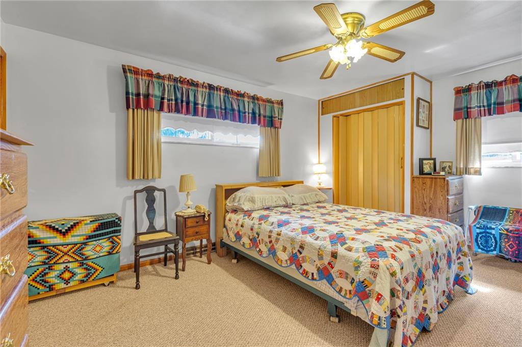 136 Kelley Road Industry, PA 15052 - Photo 7 of 35 a bedroom with a bed and a chandelier