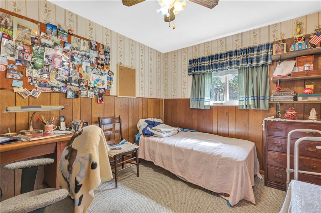 136 Kelley Road Industry, PA 15052 - Photo 9 of 35 a bedroom with a bed and a chandelier