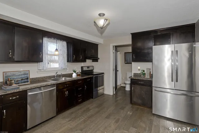 a kitchen with a refrigerator stove and microwave