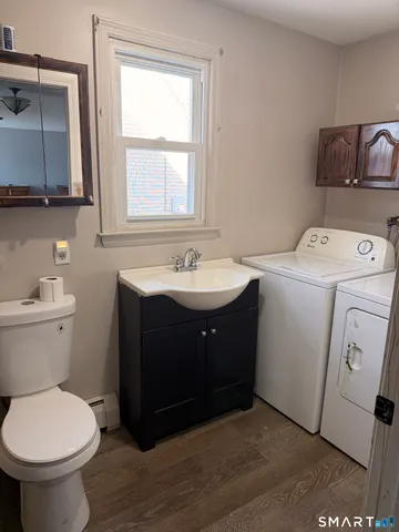 a bathroom with a sink toilet and mirror