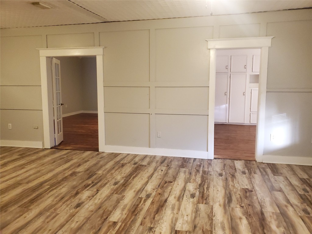 1233 Caldwell Road Angleton, TX 77515 - Photo 13 of 32 a view of empty room with wooden floor