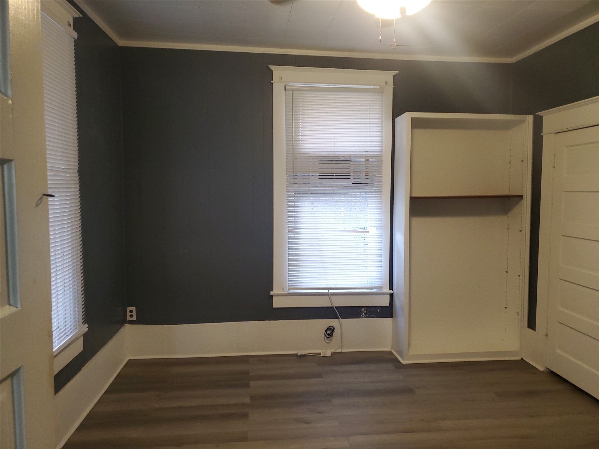 1233 Caldwell Road Angleton, TX 77515 - Photo 22 of 32 a view of an empty room with wooden floor and a window