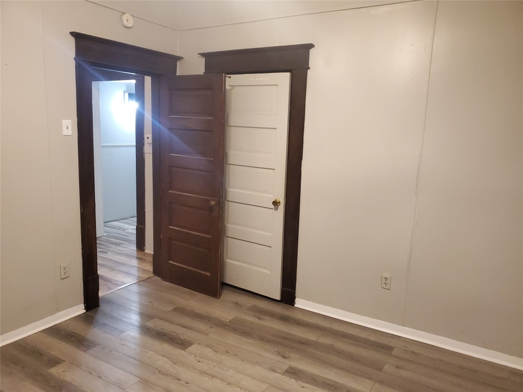 1233 Caldwell Road Angleton, TX 77515 - Photo 26 of 32 an empty room with wooden floor and closet