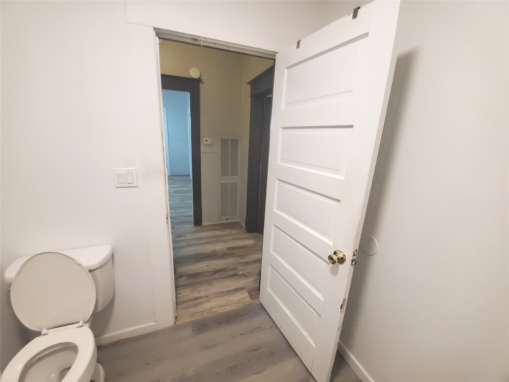 1233 Caldwell Road Angleton, TX 77515 - Photo 27 of 32 a bathroom with a toilet and a mirror