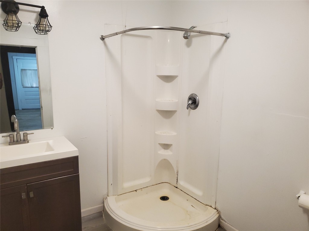 1233 Caldwell Road Angleton, TX 77515 - Photo 28 of 32 a bathroom with a sink a mirror and shower