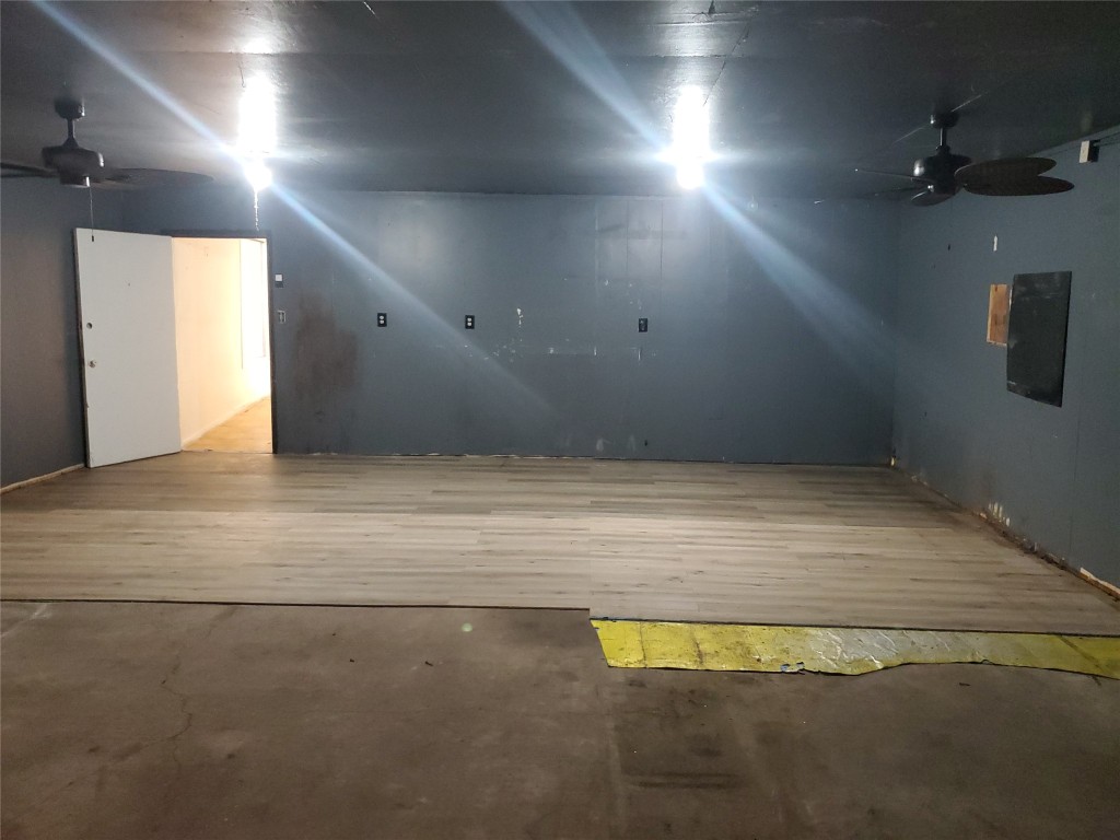 1233 Caldwell Road Angleton, TX 77515 - Photo 31 of 32 an empty room with a projector and fan