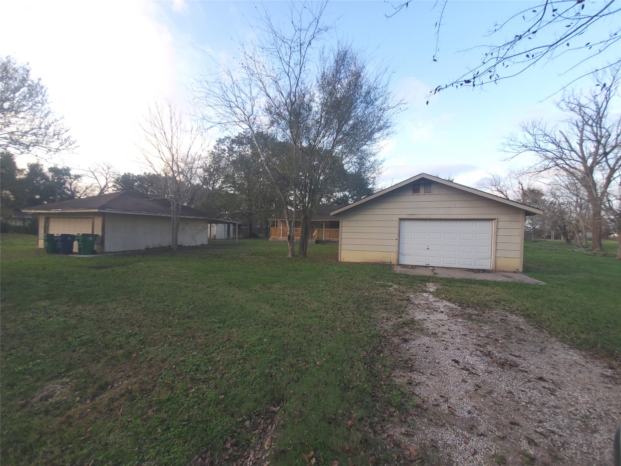 1233 Caldwell Road Angleton, TX 77515 - Photo 5 of 32 a view of a house with a yard and a large tree
