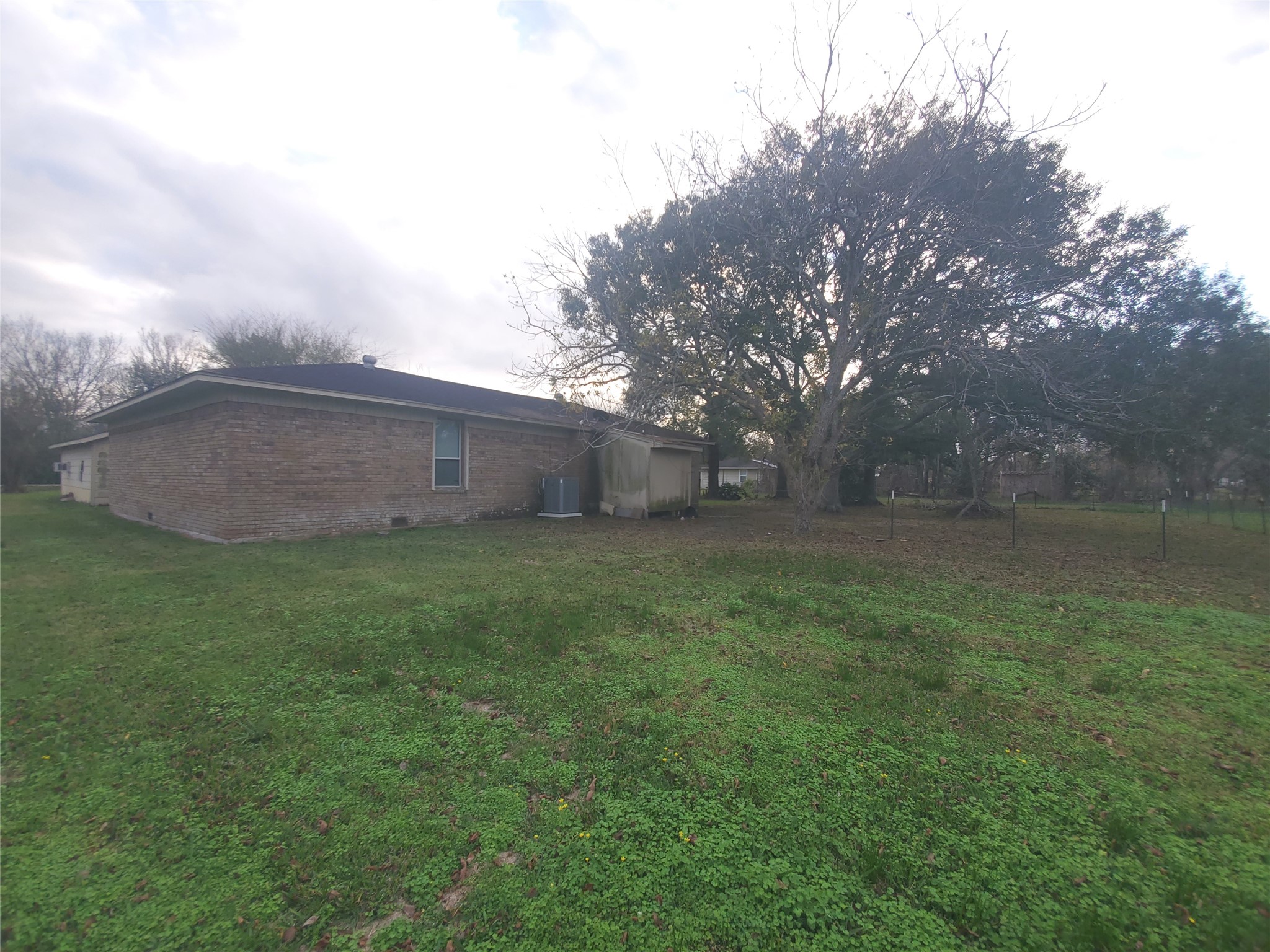1233 Caldwell Road Angleton, TX 77515 - Photo 8 of 32 a backyard of a house with lots of green space