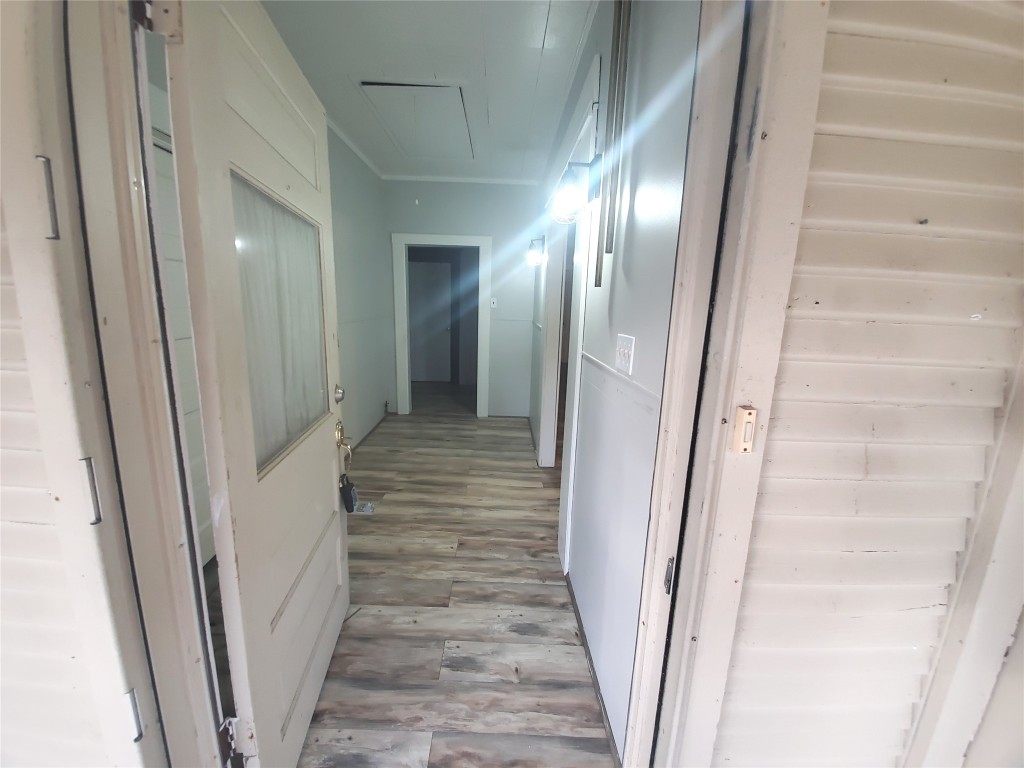 1233 Caldwell Road Angleton, TX 77515 - Photo 9 of 32 a view of a hallway with wooden floor