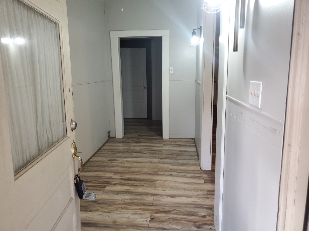 1233 Caldwell Road Angleton, TX 77515 - Photo 10 of 32 a view of a hallway with wooden floor and staircase