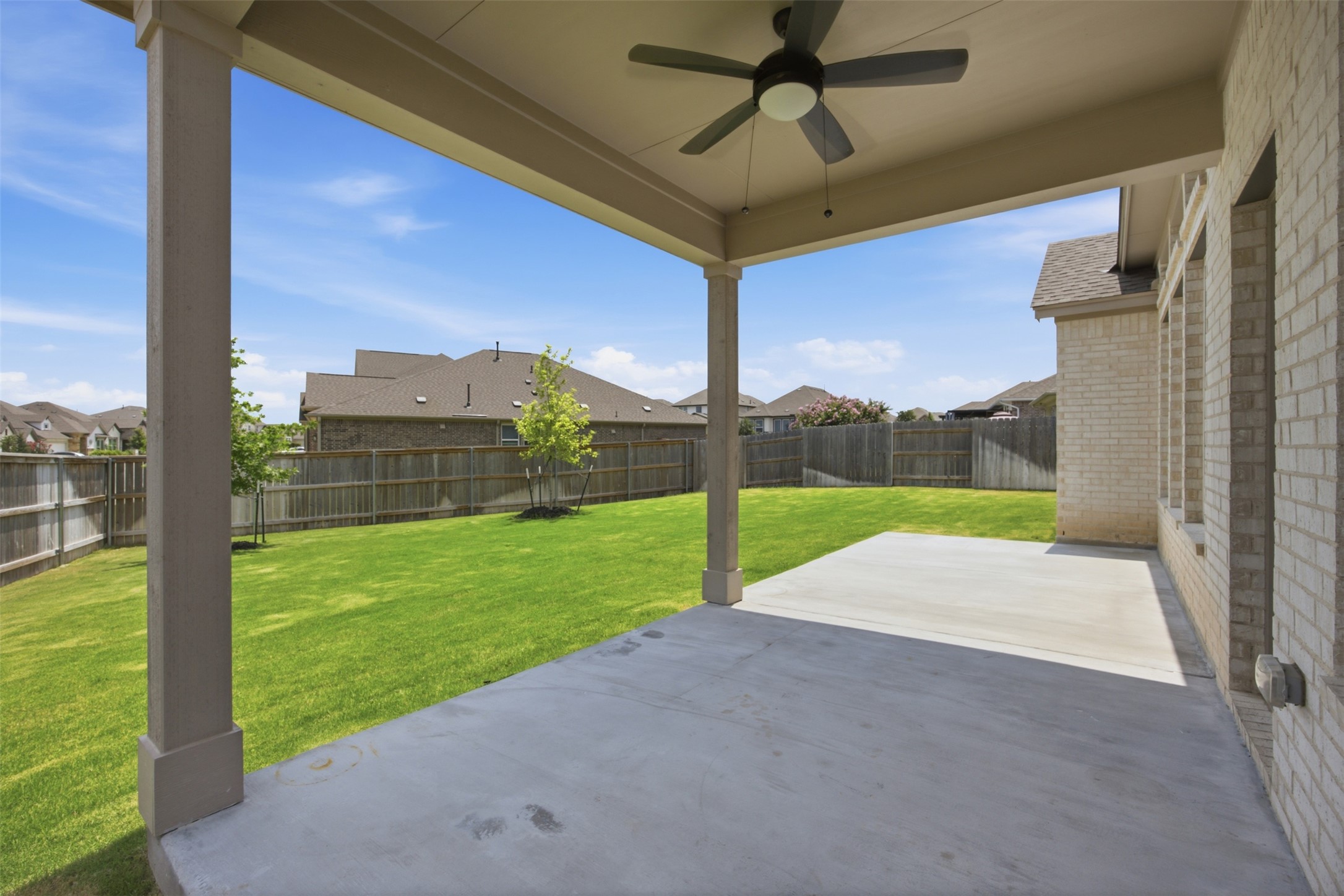 2101 Little Snake Way Georgetown, TX 78633 - Photo 33 of 37 An inviting covered patio seamlessly extends to a lush green yard, perfect for outdoor enjoyment.