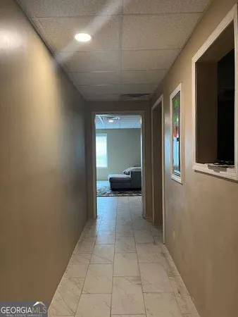 a view of a hallway with wooden shelves