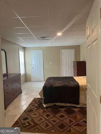 a bedroom with a bed and a dresser
