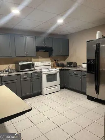 a kitchen with stainless steel appliances a stove sink and cabinets