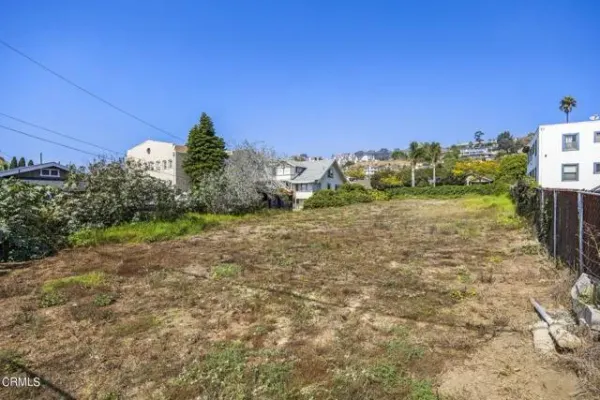 a view of a yard with an house and a yard
