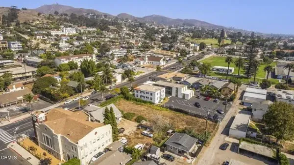an aerial view of residential houses with city view