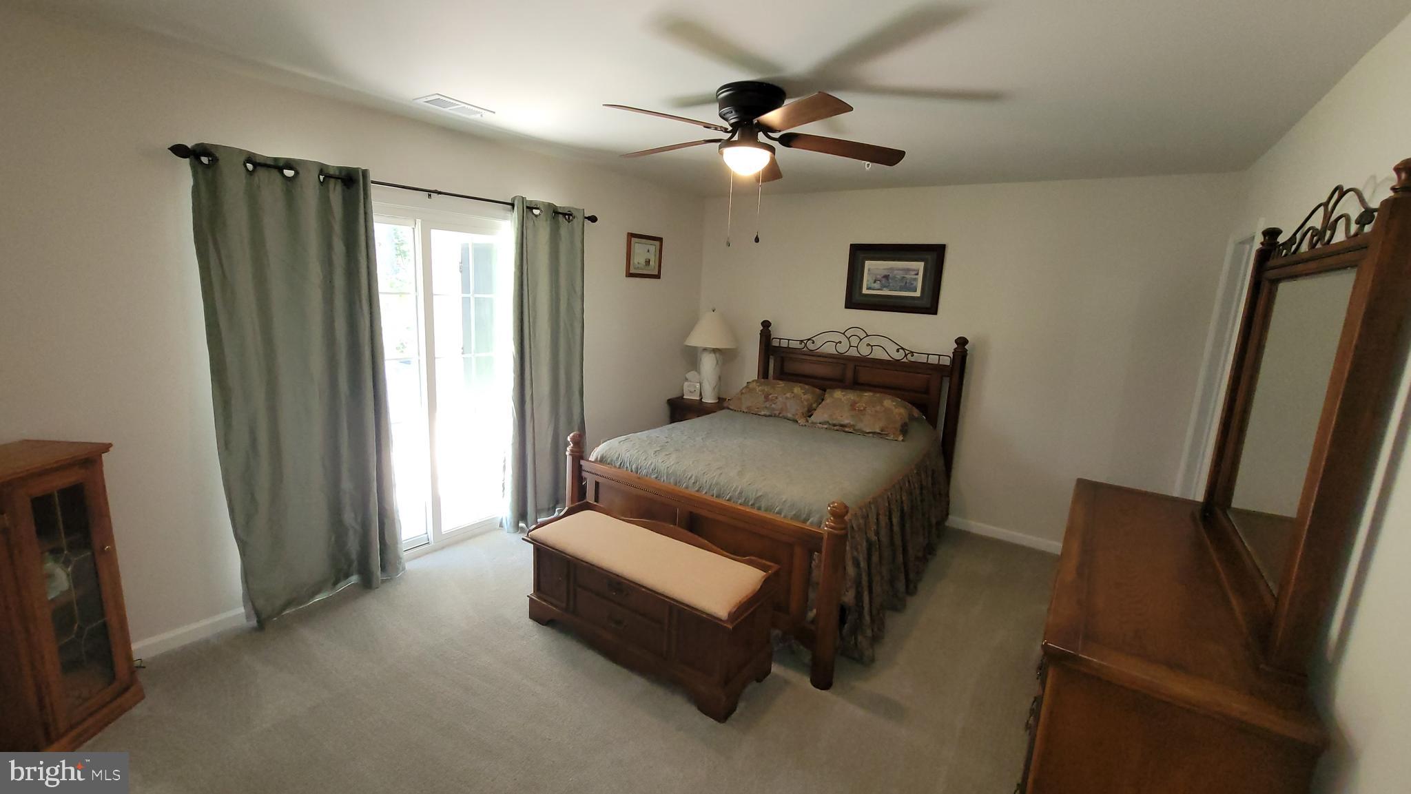 126 Metcalf Road Chestertown, MD 21620 - Photo 13 of 25 a bedroom with a bed and a chandelier