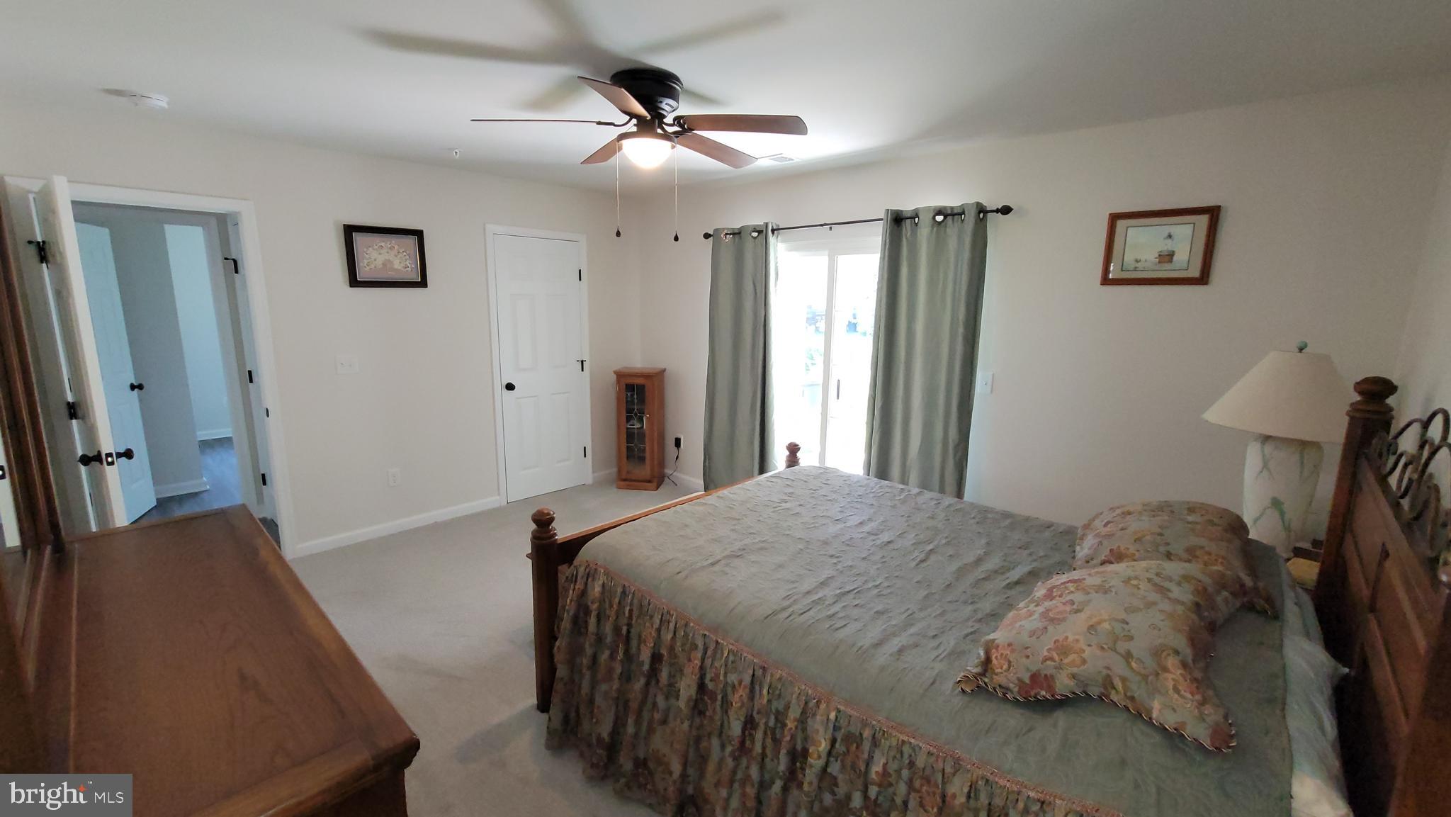 126 Metcalf Road Chestertown, MD 21620 - Photo 14 of 25 a bedroom with a bed and a chandelier