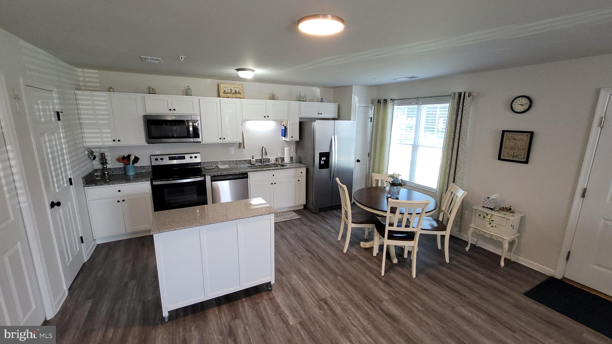 126 Metcalf Road Chestertown, MD 21620 - Photo 21 of 25 a kitchen with stainless steel appliances a stove top oven a sink dishwasher and a refrigerator with wooden floor