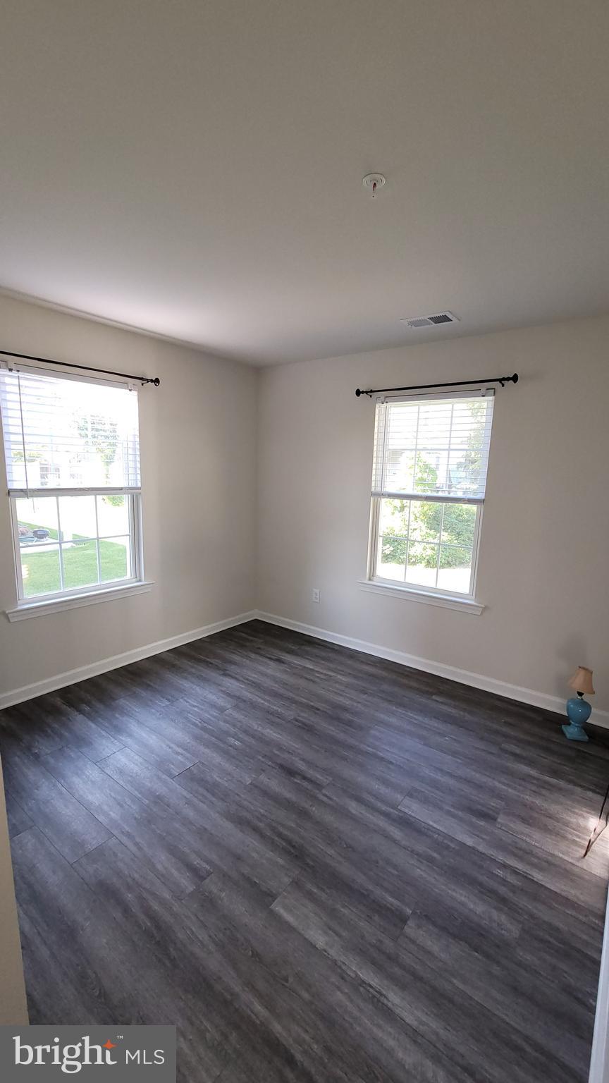 126 Metcalf Road Chestertown, MD 21620 - Photo 22 of 25 an empty room with wooden floor and windows