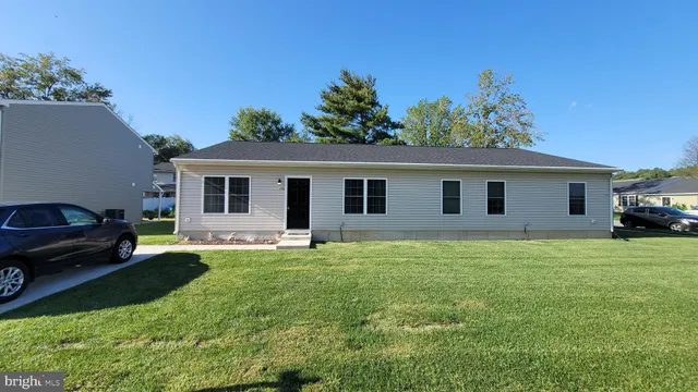 a house view with a sitting space and garden