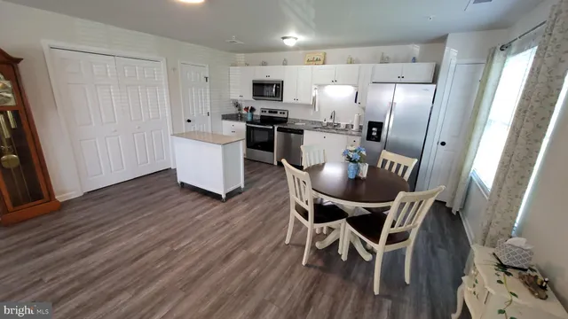 a view of a dining room with furniture and wooden floor