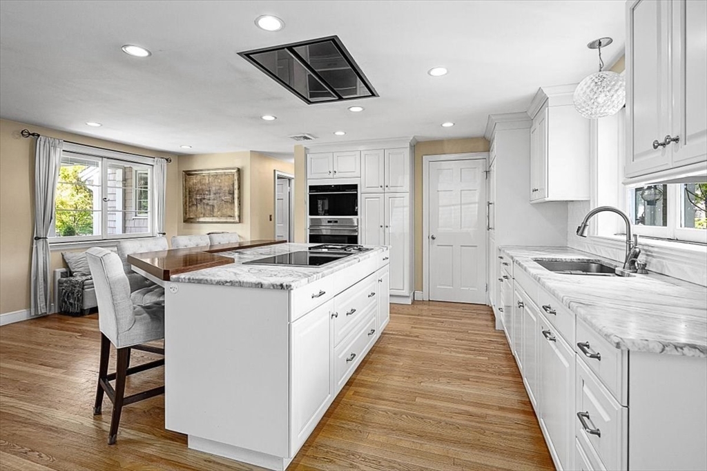 25 Howland Lane Hingham, MA 02043 - Photo 16 of 34 a large kitchen with stainless steel appliances kitchen island granite countertop a sink and cabinets