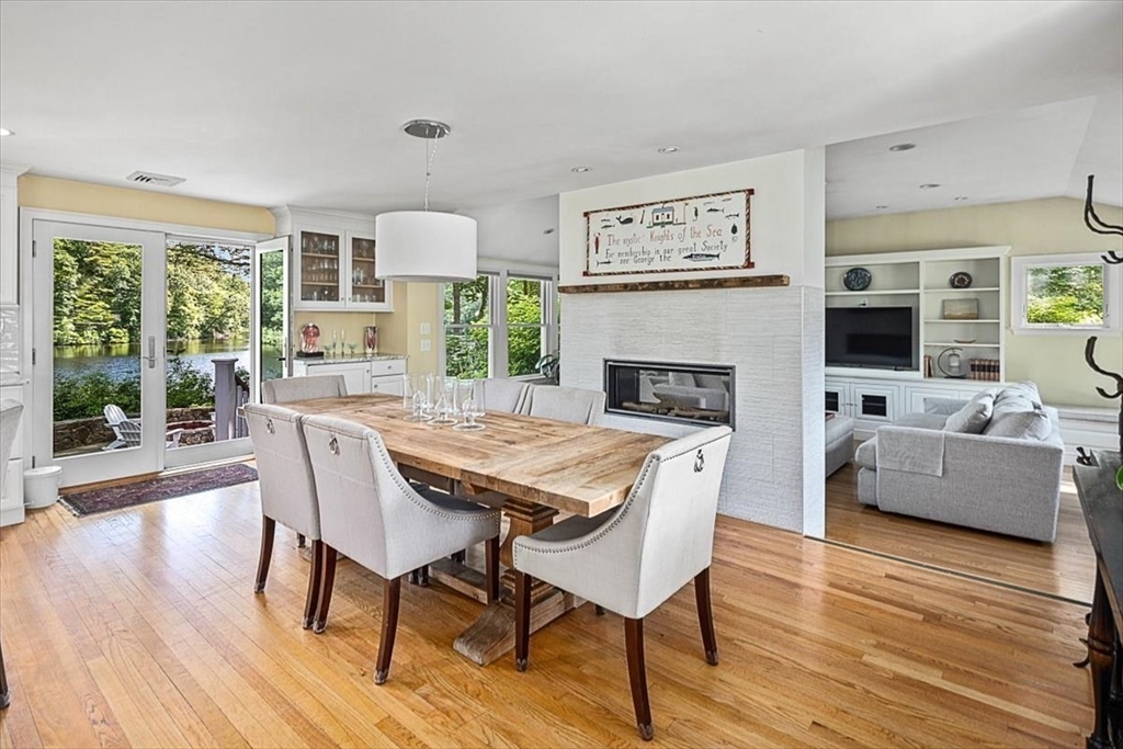 25 Howland Lane Hingham, MA 02043 - Photo 17 of 34 a dining room with furniture a fireplace and wooden floor