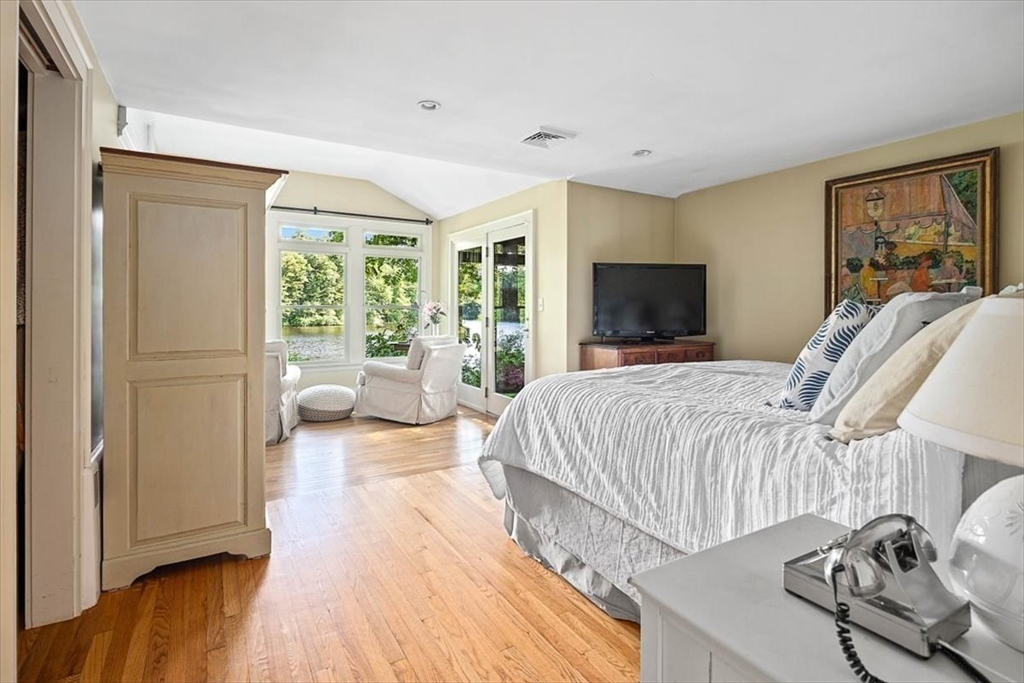 25 Howland Lane Hingham, MA 02043 - Photo 22 of 34 a bedroom with a bed and a flat tv screen