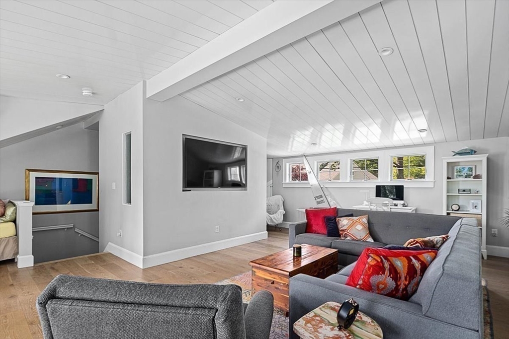 25 Howland Lane Hingham, MA 02043 - Photo 27 of 34 a living room with furniture and a flat screen tv