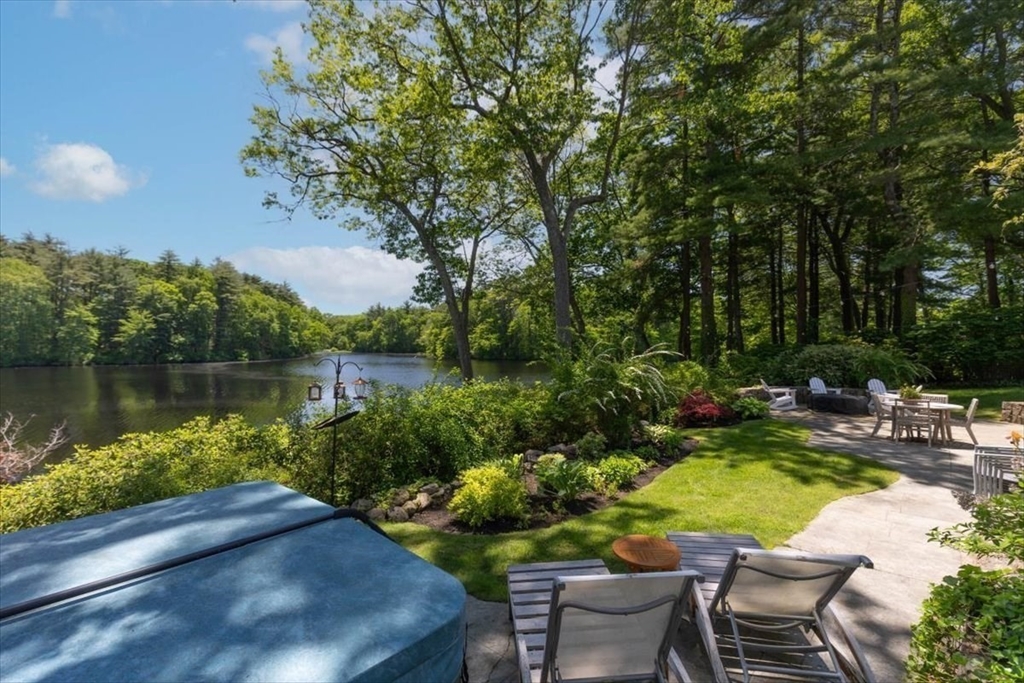 25 Howland Lane Hingham, MA 02043 - Photo 3 of 34 a view of a lake with couches and table and chairs under an umbrella