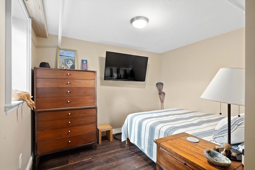 25 Howland Lane Hingham, MA 02043 - Photo 32 of 34 a bedroom with a bed and a flat screen tv