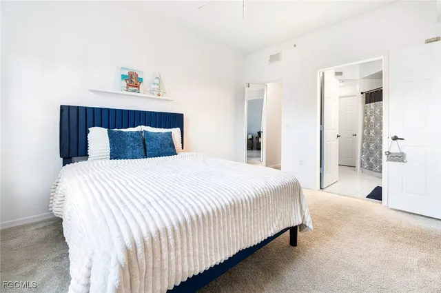 a bedroom with a bed and a painting on the wall