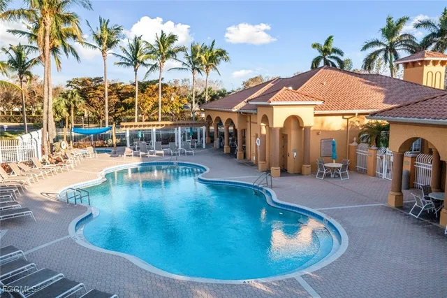 a view of a swimming pool with outdoor seating
