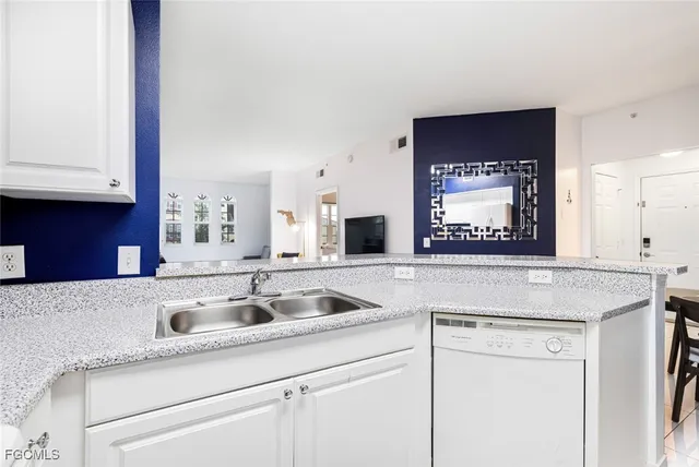 a kitchen with granite countertop a sink and cabinets