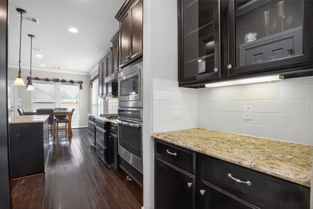a kitchen with granite countertop stainless steel appliances and wooden cabinets