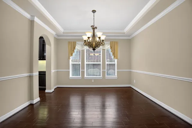 a view of wooden floor and a chandelier in a room