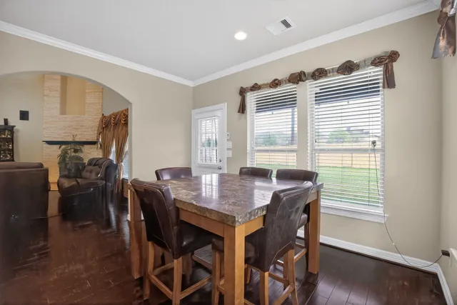 a view of a dining room with furniture and wooden floor