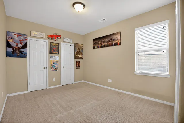 an empty room with windows and closet