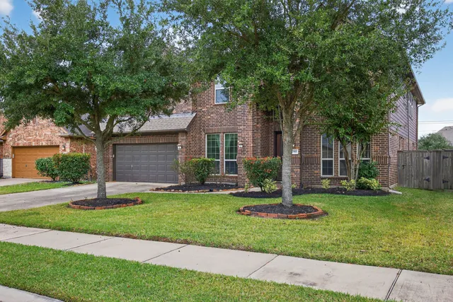 a garden with trees in front of it
