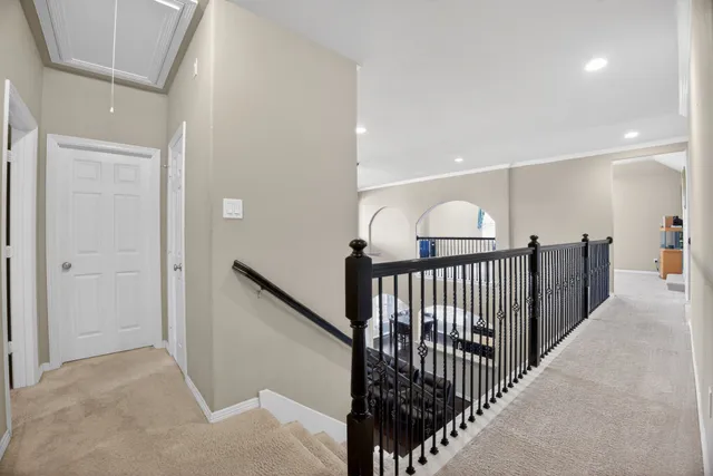 a view of staircase with lots of frames on wall and stairs