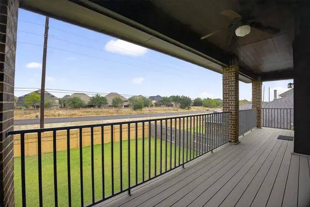 a view of balcony with wooden floor