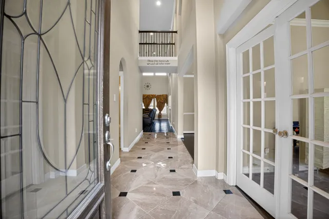 a view of a hallway with wooden floor and entryway