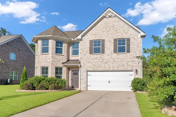 a front view of a house with a yard