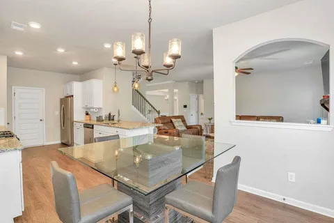 a kitchen with kitchen island stainless steel appliances and a table